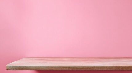 Wall Mural - light wooden table against soft pink wall background displaying simplicity