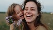 © Kantita - Joyful Moment Mother and Child Laughing Together in Meadow Holding Wildflowers Bouquet