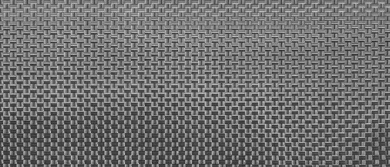 Fototapete - A black and white  background of metal with a pattern of squares. background is of a piece of cloth that is made of a woven material.