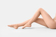 © Pixel-Shot - Legs of young woman in beige tights on light background