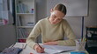 © stockbusters - Focused lady checking homework at class room closeup. Teacher putting marks