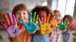 © kodidesign - Multiracial group of children showing painted smiling hands in bright classroom, symbol of diversity, creativity and joy for art education, school projects and equality campaigns.