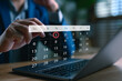 © Looker_Studio - Businessman scheduling a digital calendar on laptop, highlighting the first of the month, symbolizing time management, appointment booking, event planning, productivity, and smart scheduling system.