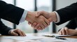 © Bima - Closing the deal: Business handshake signifies partnership and agreement