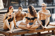 © prostooleh - Four friends in a swimwears relaxing near swimming pool