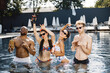 © prostooleh - Four friends in a swimwears relaxing in swimming pool