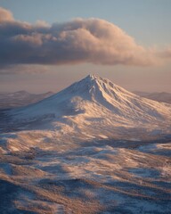 Wall Mural - Majestic Mountain Peak Covered in Snow at Sunset with Soft Clouds in the Sky Above