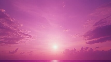 Wall Mural - Dreamy Pink Sunset Over the Ocean with Soft Clouds and a Gentle Glow of Light on the Water Surface