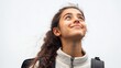 © Adi - Portrait of a happy Latin schoolgirl with a backpack looking up at the sky, isolated on a white background