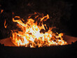 © Serg Zastavkin - Night photo of a bonfire in an iron fire bowl. Photography of flame of burning wood on black background.