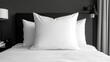 © Tibre - A simple black and white bed with three plump pillows ready to ensure a restful night