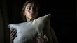 © Lumi_Studio - Woman with insomnia holding pillow in frustration, dark bedroom, realistic lighting, cinematic lighting