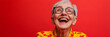 © Johnson - Joyful Senior Woman Laughing  Red Background  Glasses  Yellow Shirt