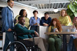 © Aida - Coworkers enjoying a coffee break, chatting and laughing together in an inclusive workplace