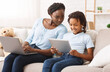 © Prostock-studio - Parental Control. Black mother watching her daughter's activity online. Copy space