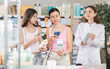 © JackF - Adult woman with daughter buyers scanning qr code for moisturizing cream with young woman pharmacist in pharmacy
