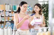 © JackF - Selective mom and daughter scanning QR-code on pack of feminine pads in drugstore
