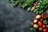 Flat lay of fresh vegetables herbs and tomatoes on dark background with textured surface