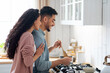 © Prostock-studio - Couple Cooking Together Concept. Young arab spouses preparing dinner in kitchen, handsome middle eastern man stirring meal with spatula while wife embracing him from the back, side view, free space