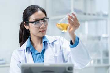 Wall Mural - asian researcher using a microscope in the clinical lab.female researcher working in the clinical la