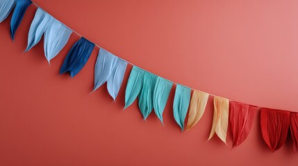 Poster - Brightly colored tissue paper garlands adorn a coral wall, adding a lively touch to any occasion with open space on the right for additional design elements