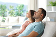 © Antonioguillem - Couple relaxing sitting in a couch of a luxury house