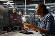 © DC Studio - Scared admin in data center panicked by virus alert, initiating protocol to protect critical systems. African American woman in server room assessing compromised gear after hacker attack