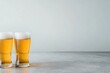 © Garik - Refreshing golden beer served in glasses on a smooth grey surface in a casual setting
