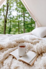 Wall Mural - Cozy camping morning with hot tea and open book in forest tent retreat