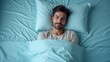 © PremiumPhoto - Morning Coffee Routine. Smiling man with beard lying blue bed sheets r