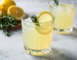 © Swetha - refreshing lemon and rosemary mocktail setup with fresh herbs and zesty flavors