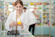 © ultramansk - A woman pharmacist inspects a medication bottle, ensuring accuracy in prescription filling. pharmacists in patient safety and careful medication handling. daily operations in a modern pharmacy.