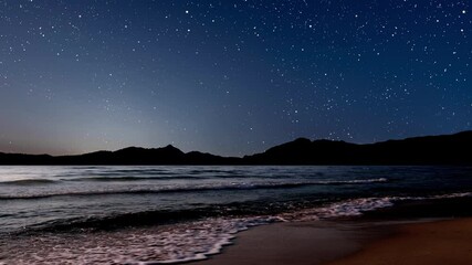 Wall Mural - a a movement of stars in the night sky with the view of mountains.