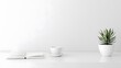 © habibah - Simple, minimalist workspace featuring a plant, book, and cup.