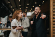 © qunica.com - A lively outdoor setting where business professionals are engaging in a friendly and cheerful conversation, showcasing teamwork and professionalism in a modern work environment.