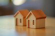 © xadartstudio - Two small wooden houses on a table a home concept