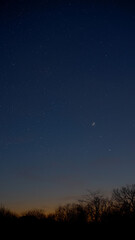 Wall Mural - crescent young moon with stars, planets and countryside silhouettes.