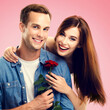 © vgstudio - Love, relationship, dating, flirting, romantic concept - portrait of happy couple, man woman, girlfriend boyfriend wear casual denim shirt cloth hold rose flower, isolate pink background. Square image