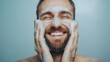 © pkproject - Smiling man washing his face in the bathroom, representing a refreshing morning routine