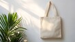 © Photo - Natural canvas tote bag placed on white background with gentle lighting