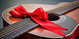 A bright red ribbon tied in a string loop around a metal music instrument handle , instrument parts