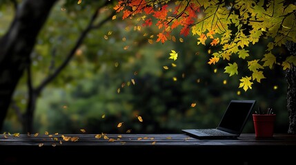 Wall Mural - autumnal scenery with a laptop on a wooden table.