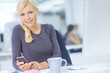 © peopleimages.com - Phone, portrait and smile with business woman at desk in office for communication or networking. Company, desktop and internet with happy designer typing text message on mobile in creative workplace