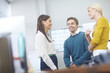 © peopleimages.com - Break, business people and relax in office for discussion, conversation and good news on startup project. Creative agency, women and man with happiness for teamwork, announcement and feedback