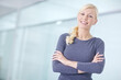 © peopleimages.com - Woman, office and arms crossed in portrait with smile, corporate career with administrative job. Female receptionist, happiness and confidence in workplace for business, employee with mockup space