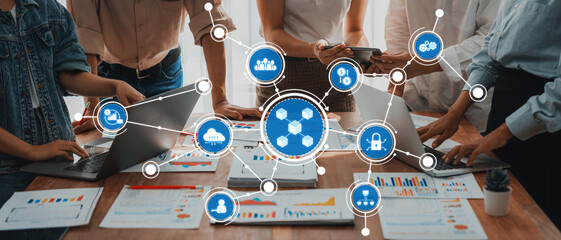 Fototapete - A diverse team collaborates in a modern office setting, utilizing technology and digital tools to analyze data and performance metrics displayed on laptops and reports. Amity