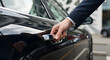 © abu - Close Up of Hand Opening Black Car Door in Dark Blue Suit for Arrival and Departure on Urban Street