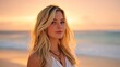 © Akash - Blonde woman in white sun dress posing on sandy beach at sunset
