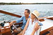 © BuyoutReese08/peopleimages.com - Man, woman and ocean adventure or together in boat on holiday, relax on cruise date for retirement travel. Mature, happy couple and water yacht for vacation with happiness, outdoor summer in Bali