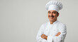 © LORA - Smiling Professional Male Chef in Uniform and Hat with Arms Crossed on Light Background